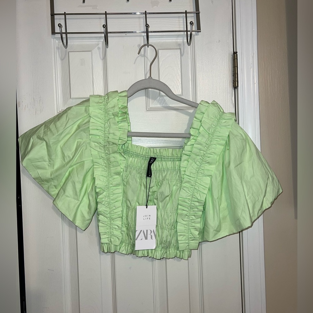 Green pleated blouse